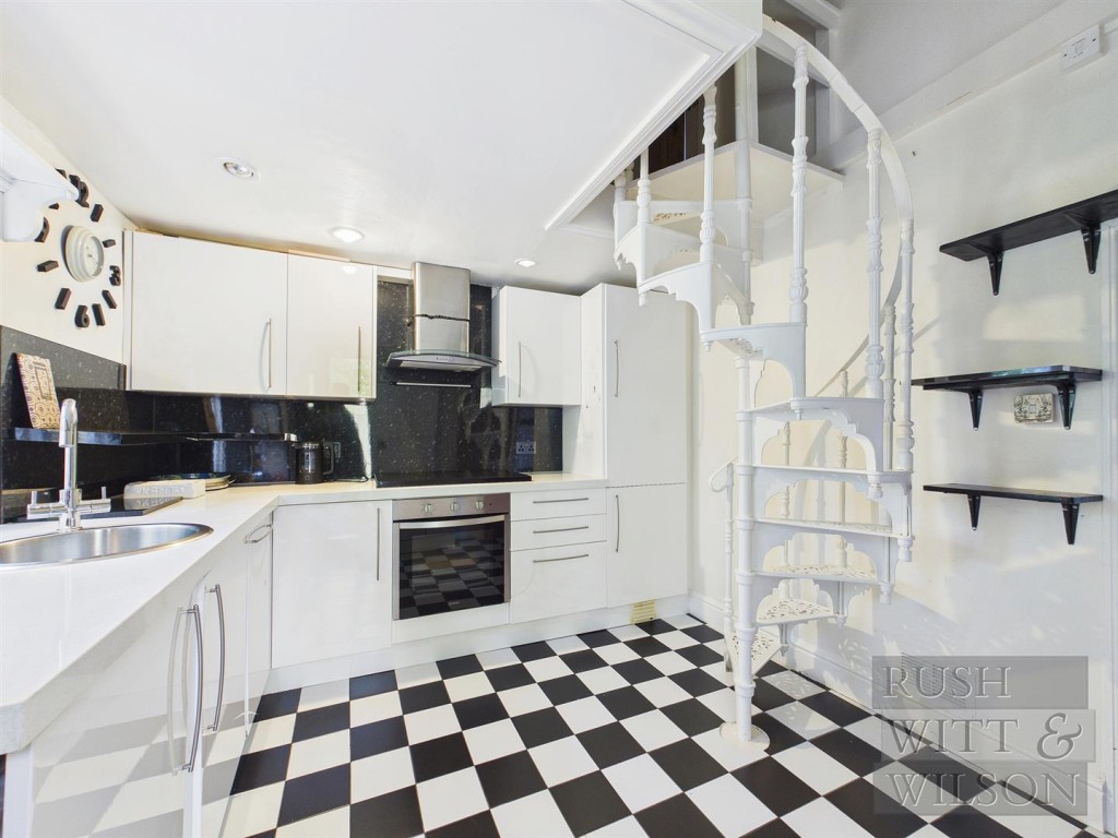 Lot: 123 - SEMI-DETACHED COTTAGE FOR REFURBISHMENT WITH FAR REACHING VIEWS - Kitchen showing stairs